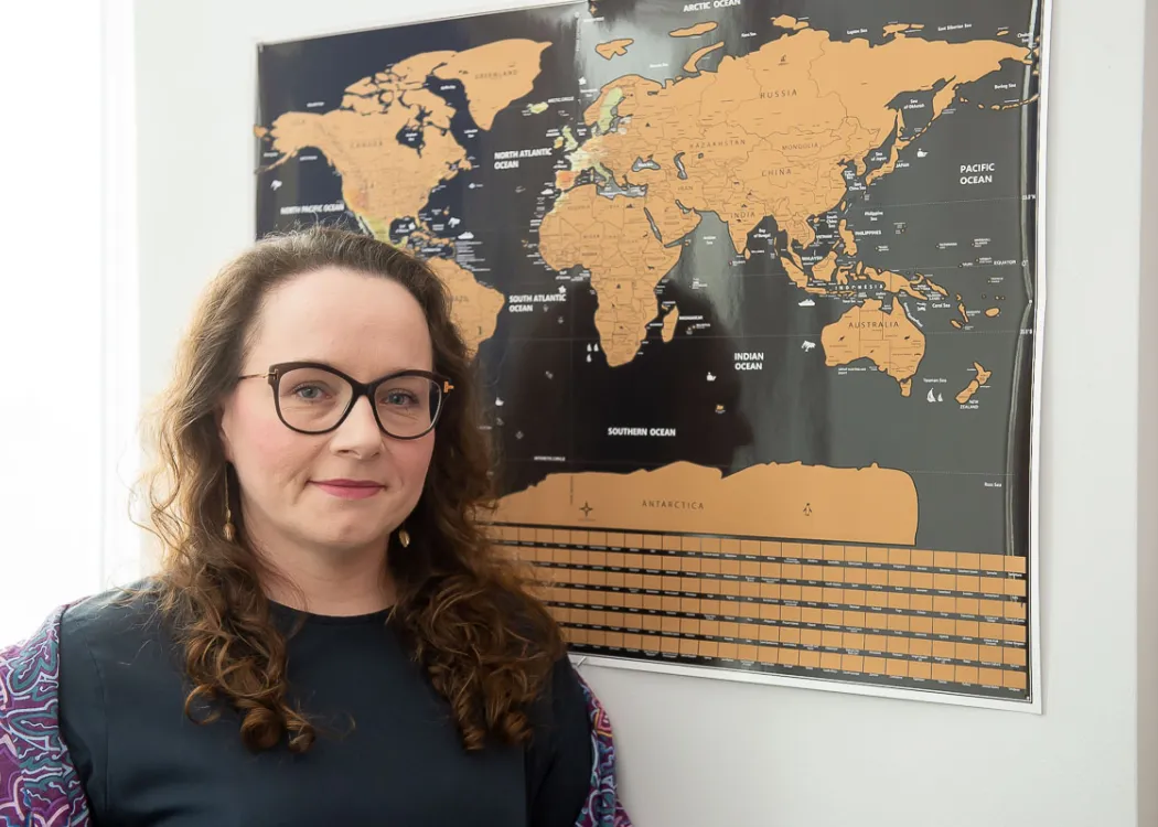 Dr Dominika Kuberska przy mapie świata