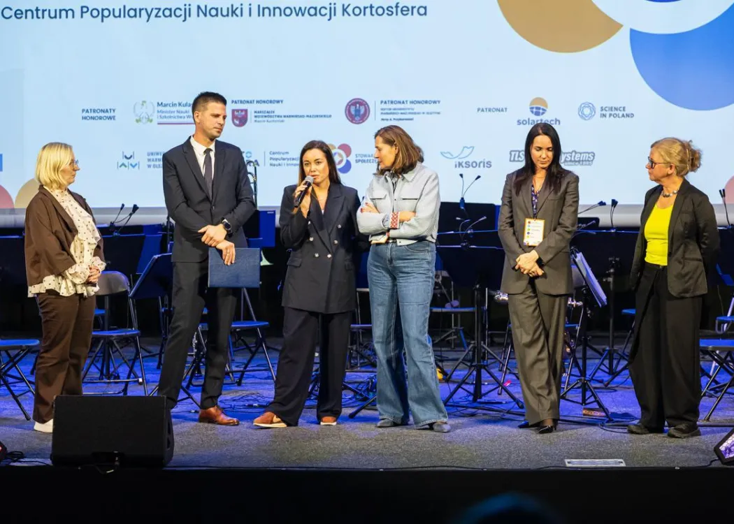 Konferencja SPIN: organizatorzy stoją na scenie 