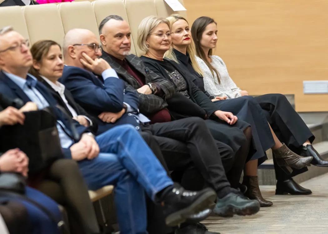 Uczestnicy wydarzenia siedzą w auli teatralnej