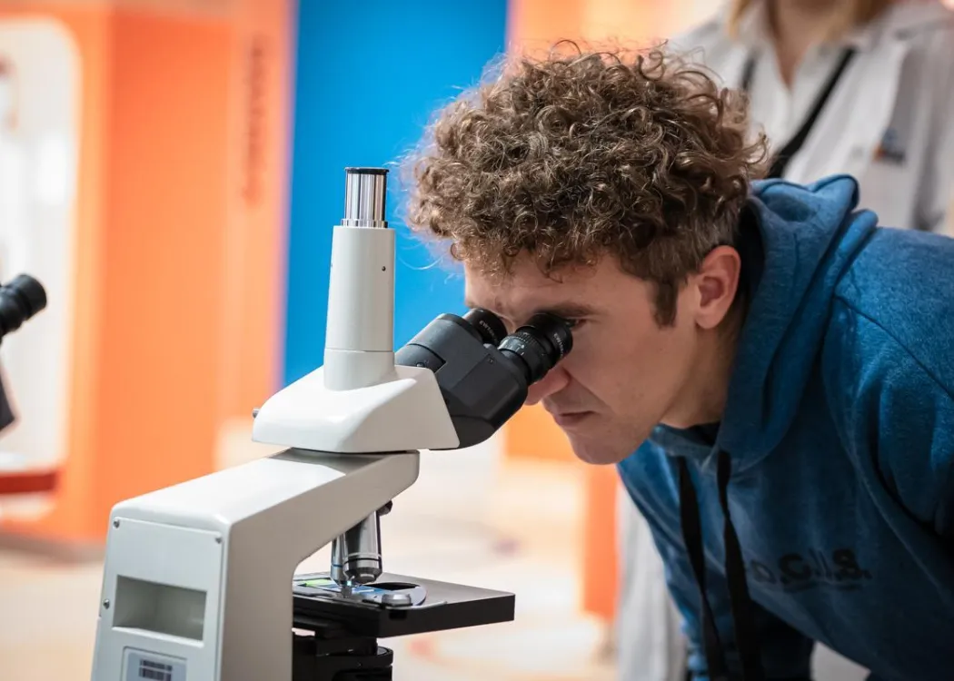 Noc Biologów 2026: mężczyzna patrzy przez mikroskop