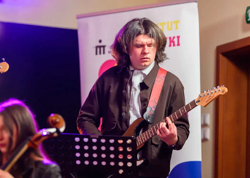 student gra na gitarze