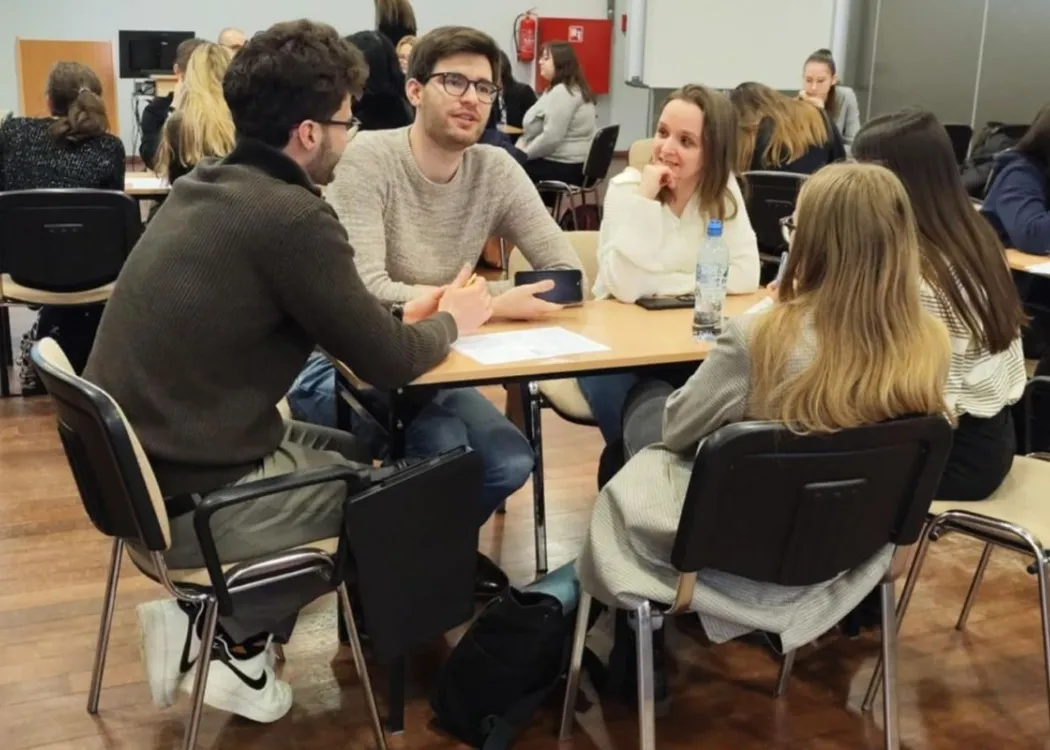 studenci siedzą i omawiają plan biznesowy przedsiębiorstwa społecznego