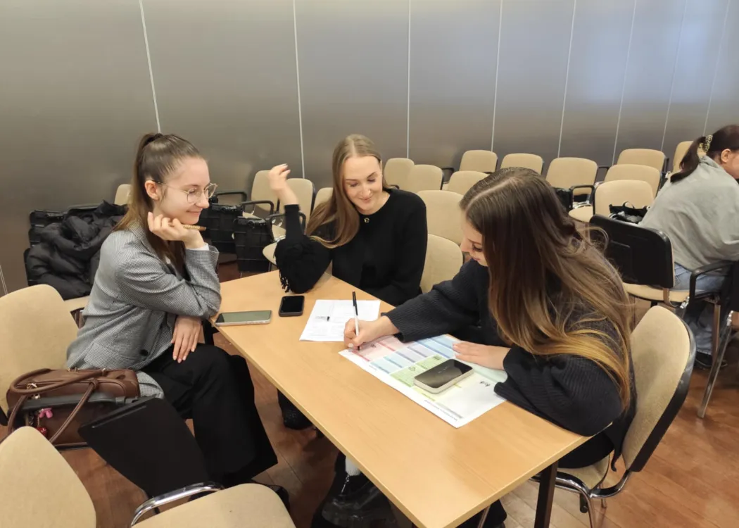 studenci siedzą i omawiają plan biznesowy przedsiębiorstwa społecznego