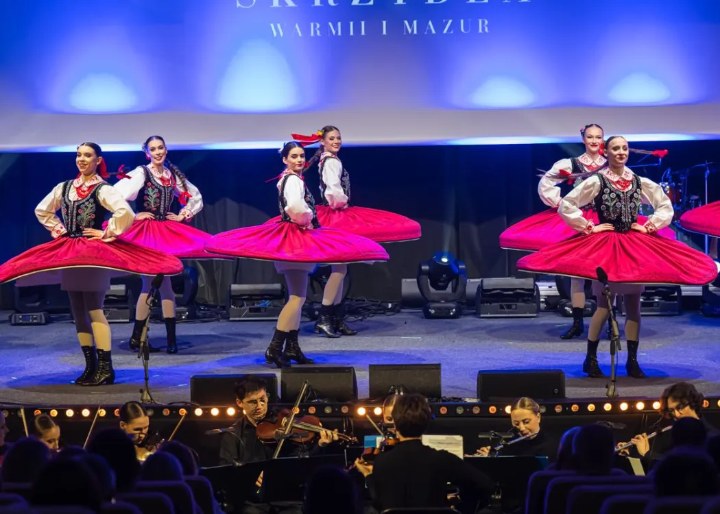Gala Skrzydła Warmii i Mazur: kobiety w strojach ludowych wirują czerwonymi spódnicami