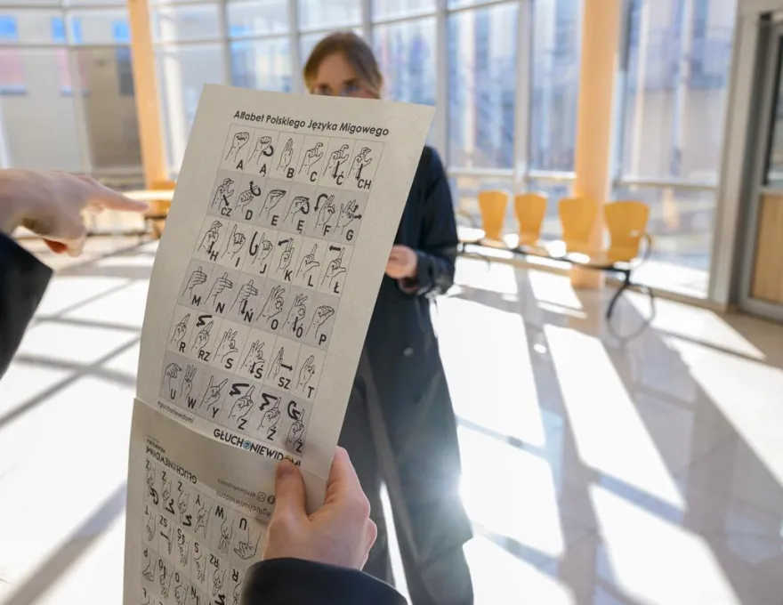 na zdjęciu widać kartkę papieru z alfabetem języka migowego, zostało ono zrobione podczas obchodów Europejskiego Dnia Logopedy w 2025 roku 