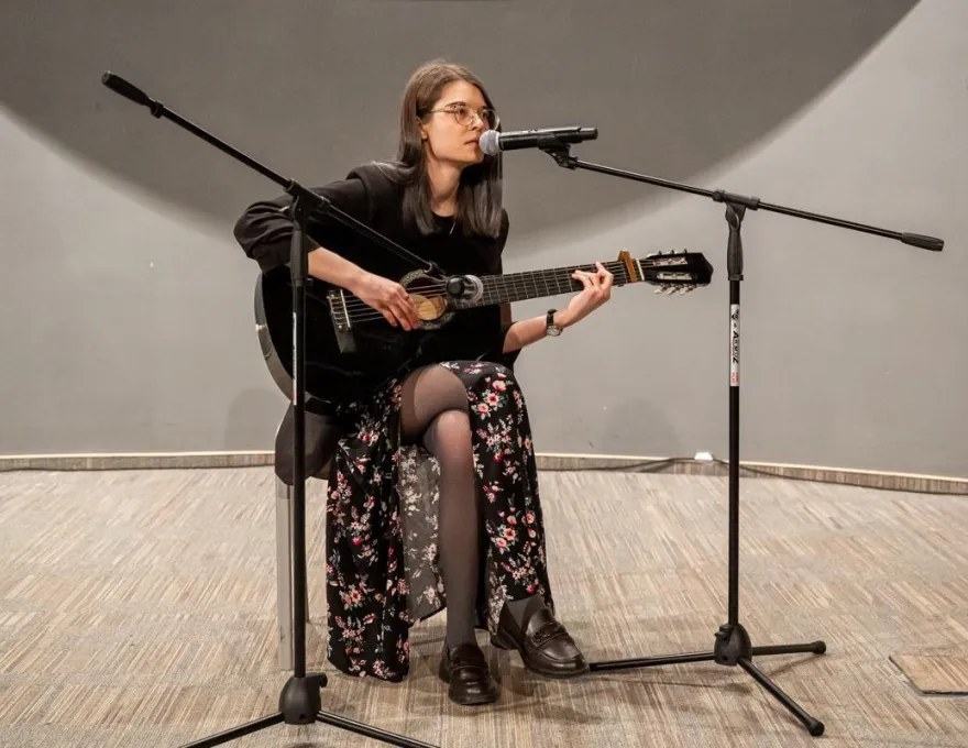 studentka występująca na scenie z gitarą