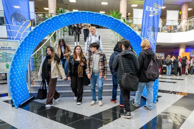 Student EXPO 2025: studenci przechodzą pod banerem z logo UWM 