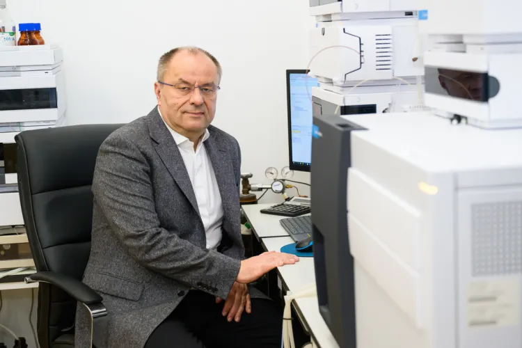 Prof. Łukasz Zielonka siedzi przy biurku